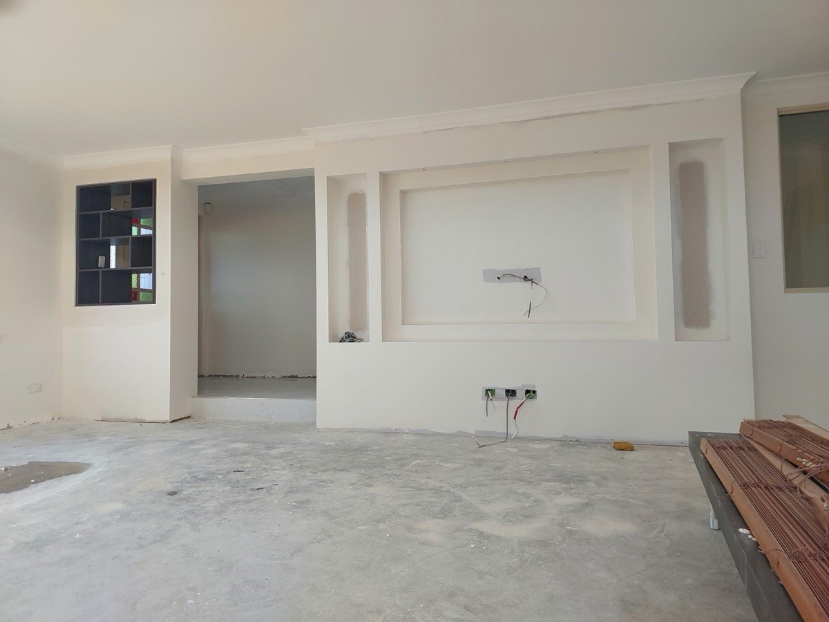 Custom plasterboard feature wall with recessed niches, bulkhead and shadowline detail