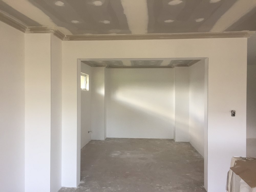 Cornice, ceiling and a square-set opening between two rooms, finished ready for paint